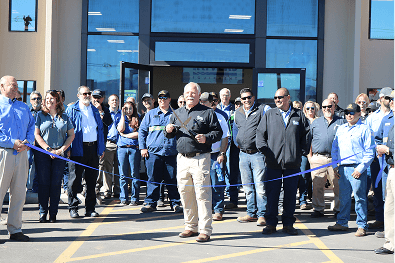 Group of people at ribbon-cutting ceremony outdoors