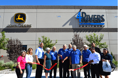 Group in front of building with John Deere and 4Rivers Equipment logos