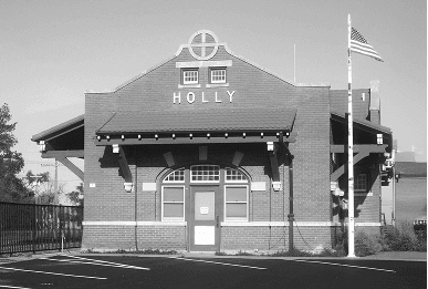 Two-story building with HOLLY visible on facade