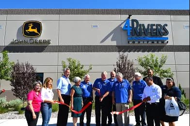 Group in front of building with John Deere and 4Rivers Equipment logos