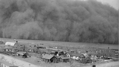 Black and white photograph of a severe dust storm over a rural landscape