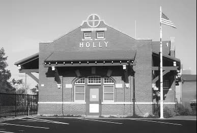 Two-story building with HOLLY visible on facade