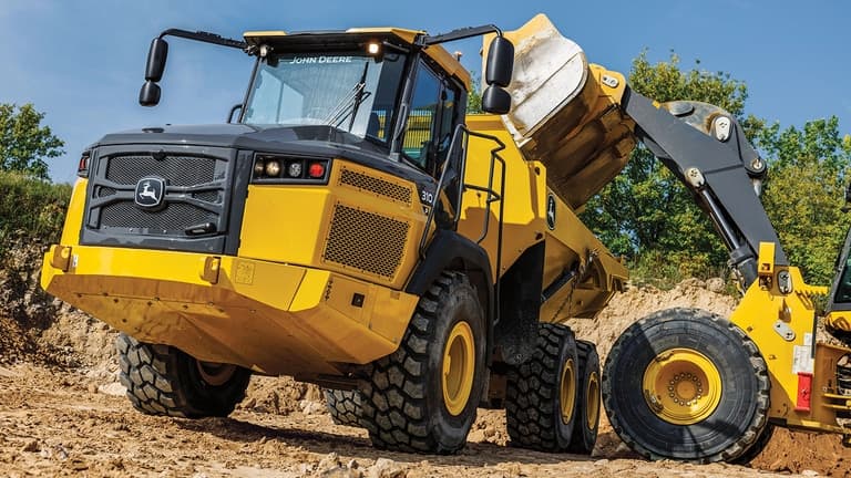 A wheeled loader dumping dirt into a 310P Articulated Dump Truck. | 4re Equipment