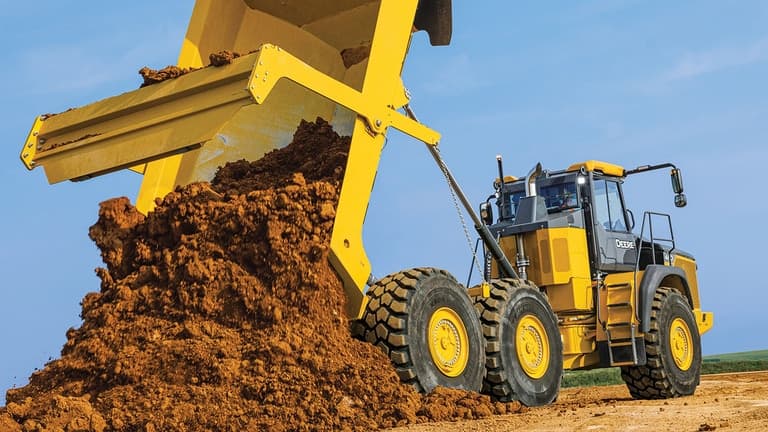 A 460P Articulated Dump Truck dumping dirt onto a worksite. | 4re Equipment