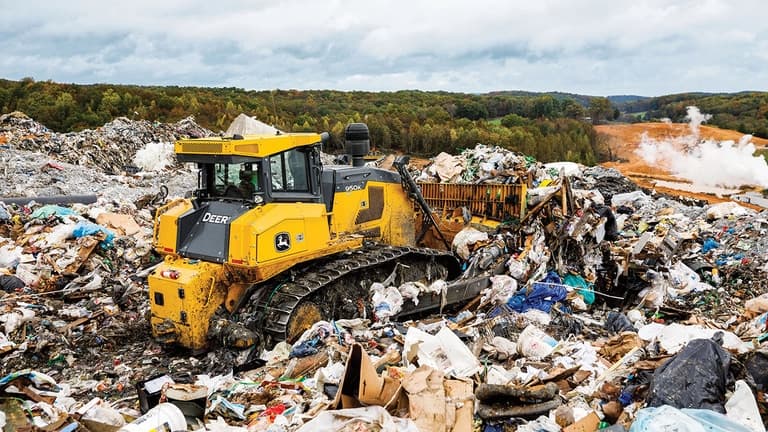 A 950K Dozer pushing garbage into piles at a landfill. | 4re Equipment