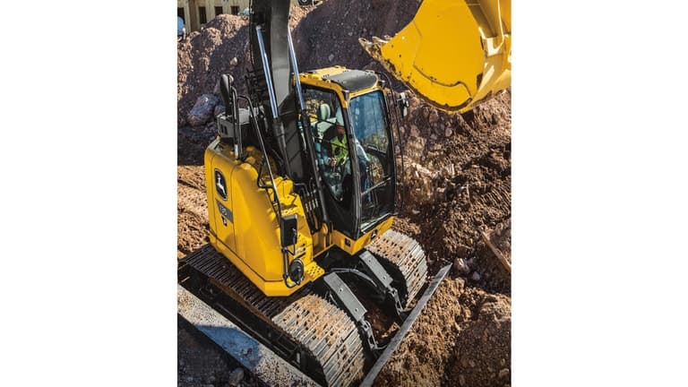 A side-view of the 135P-Tier Excavator surrounded by dirt piles. | 4re Equipment