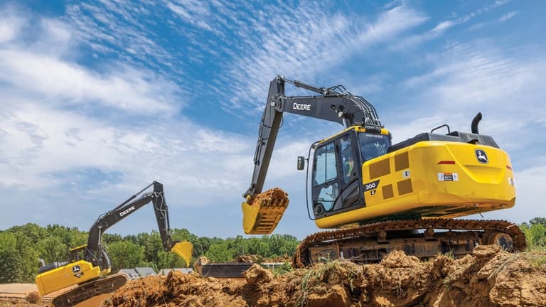 A 200G Excavator moving dirt at a worksite with a 180P-Tier Excavator also moving dirt in the background. | 4re Equipment