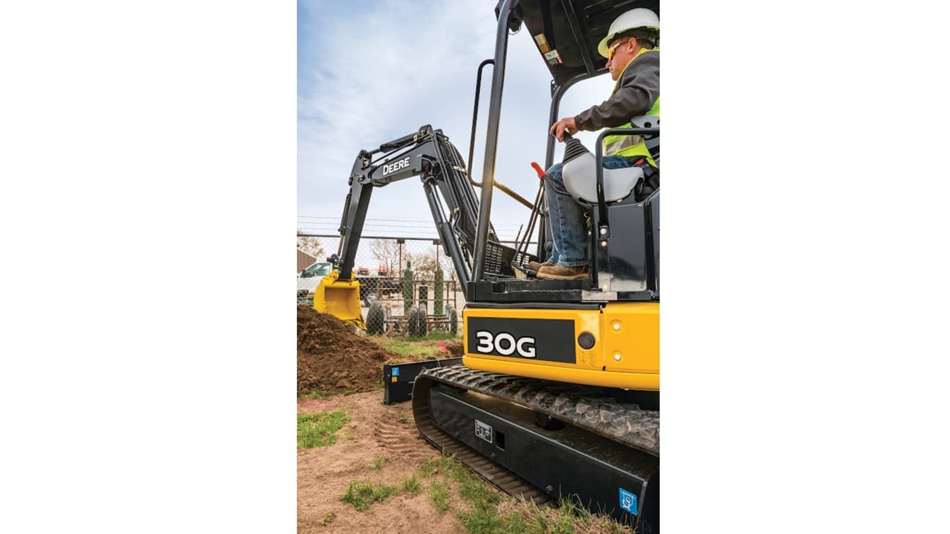 Operator using a 30G excavator to move topsoil in front of a fence. | 4re Equipment | ID: 030gxff