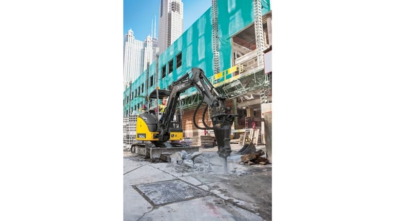 An operator using a 30G Excavator with an HH60C hammer attachment to break up concrete at a worksite. | 4re Equipment