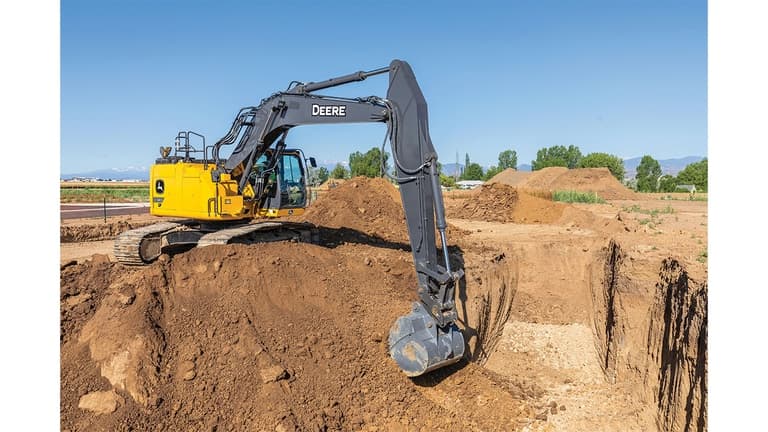 A 345P-Tier Excavator scooping dirt out of a pit at a worksite. | 4re Equipment