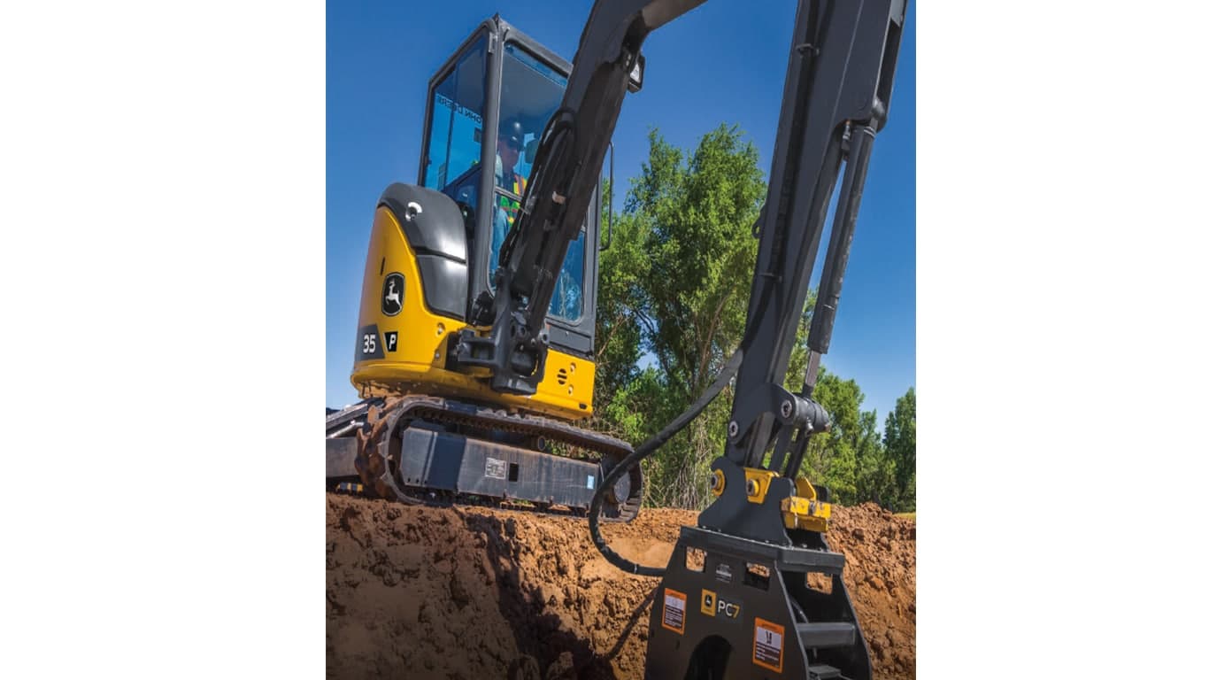 An operator using a 35P-Tier Excavator with P7 plate compactor attachment to compact dirt at a worksite. | 4re Equipment | ID: 35PEXFT4