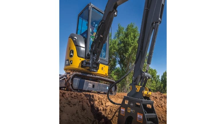 An operator using a 35P-Tier Excavator with P7 plate compactor attachment to compact dirt at a worksite. | 4re Equipment