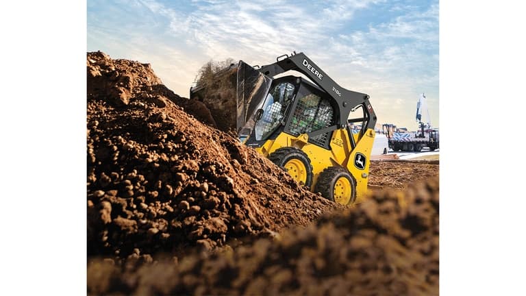 A 318G Skid Steer moves rock and dirt on unleveled terrain. | 4re Equipment