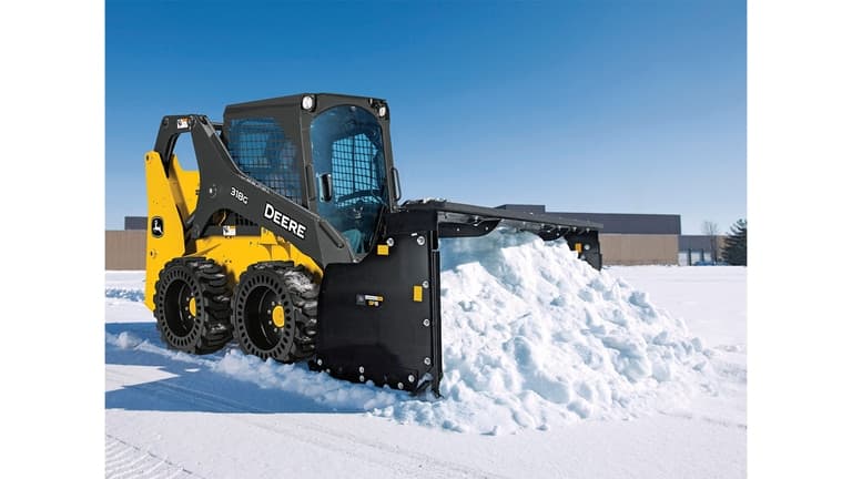 A 318G Skid Steer moves rock and dirt on unleveled terrain. | 4re Equipment
